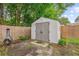 Backyard storage shed with double doors and secure latch on a well-maintained property at 112 Red Cypress Dr, Goose Creek, SC 29445
