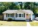 Charming single-story home with gray siding, black shutters, and a pink front door at 1159 Camden St, North Charleston, SC 29405
