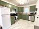 Modern kitchen with stainless steel appliances, olive green cabinets, and marble flooring at 1159 Camden St, North Charleston, SC 29405
