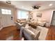 Inviting living room with plush seating, ceiling fan, hardwood floors, and natural light at 1159 Camden St, North Charleston, SC 29405
