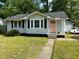 Charming single-story home with light gray siding, black shutters, and a vibrant pink front door at 1159 Camden St, North Charleston, SC 29405