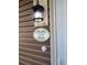 Close-up of the house number plaque displaying '117 Weiters St.' with ivy design and light fixture at 117 Weiters St, Walterboro, SC 29488