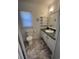 Bathroom with gray countertop, cabinets, toilet, and a window at 117 Weiters St, Walterboro, SC 29488