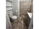 This bathroom features a shower with patterned curtain, gray vanity and unique tile floors at 117 Weiters St, Walterboro, SC 29488