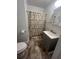 Bathroom features gray vanity and patterned shower curtain at 117 Weiters St, Walterboro, SC 29488
