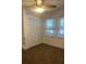 This bedroom features neutral carpeting, closet and two windows for natural light at 117 Weiters St, Walterboro, SC 29488