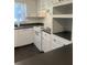 Modern kitchen with white cabinetry, black countertops, and matching white appliances at 117 Weiters St, Walterboro, SC 29488
