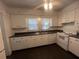 Bright kitchen features white cabinets, black countertops, and modern appliances at 117 Weiters St, Walterboro, SC 29488