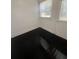 This room has black wood flooring, a window and a door at 117 Weiters St, Walterboro, SC 29488