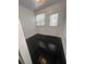 This room has black wood flooring, a window and a door at 117 Weiters St, Walterboro, SC 29488