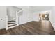 Open-concept living area with wood-look floors and a staircase at 122 Hornby Cir, Goose Creek, SC 29445