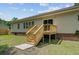 The rear exterior of the house showcasing a deck with stairs, sliding doors and lawn at 123 Fall Creek Blvd, Summerville, SC 29483