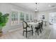 Airy dining room with natural light from large windows, a decorative chandelier and modern accents at 123 Fall Creek Blvd, Summerville, SC 29483