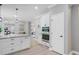 Bright, open concept kitchen featuring white cabinetry, granite countertops, and stainless steel appliances at 123 Fall Creek Blvd, Summerville, SC 29483
