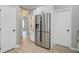 Modern kitchen with stainless steel refrigerator and plenty of cabinet space, leading to a hallway and other rooms at 123 Fall Creek Blvd, Summerville, SC 29483