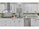 Updated kitchen boasts granite countertops, stainless steel appliances, and sleek white cabinetry for a contemporary feel at 123 Fall Creek Blvd, Summerville, SC 29483