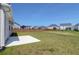 This open backyard features a concrete patio with a well-maintained lawn at 124 Long Trail Way, Moncks Corner, SC 29461