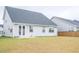Spacious backyard with a view of the home's light gray exterior and back patio at 124 Long Trail Way, Moncks Corner, SC 29461