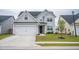 Beautifully designed two-story house with a spacious driveway and lush green lawn adding to its charm at 124 Long Trail Way, Moncks Corner, SC 29461