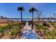 Picturesque fishing pier adorned with palm trees, offering stunning waterfront views and a serene spot for outdoor activities at 124 Long Trail Way, Moncks Corner, SC 29461