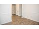 Bright room featuring laminate wood flooring, white walls, and modern trim work at 124 Long Trail Way, Moncks Corner, SC 29461