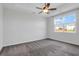 The bright main bedroom has a ceiling fan and tray ceiling with a window at 124 Long Trail Way, Moncks Corner, SC 29461