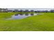 This community pond is surrounded by well-manicured green grass at 124 Long Trail Way, Moncks Corner, SC 29461