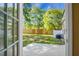 Spacious backyard with patio and lush greenery visible through the glass door at 129 Mockernut Dr, Ladson, SC 29456