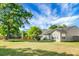 Expansive backyard featuring a green lawn, mature trees, wooden fence, and space for outdoor furniture at 129 Mockernut Dr, Ladson, SC 29456