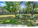 Expansive backyard equipped with a fire pit, seating, and a trampoline, perfect for outdoor enjoyment at 129 Mockernut Dr, Ladson, SC 29456
