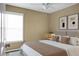 Cozy bedroom featuring a neutral color scheme, ceiling fan, and warm lighting at 129 Mockernut Dr, Ladson, SC 29456