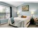 Comfortable bedroom boasts blue walls, queen-sized bed, and a window for natural light at 129 Mockernut Dr, Ladson, SC 29456