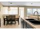 Open dining area with views to adjoining sunroom featuring tile flooring and updated features at 129 Mockernut Dr, Ladson, SC 29456