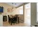 Dining room with a dark wood table, chairs, modern lighting, and neutral walls at 129 Mockernut Dr, Ladson, SC 29456
