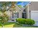 Close up of a home exterior with manicured bushes and front lawn at 129 Mockernut Dr, Ladson, SC 29456