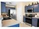 Bright and modern kitchen with stainless steel appliances, blue cabinets, and sleek countertops at 129 Mockernut Dr, Ladson, SC 29456