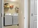 Laundry room with a white washer, white dryer, storage shelves, and white door at 129 Mockernut Dr, Ladson, SC 29456