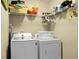 Laundry room with a white washer, white dryer, and shelves stocked with items at 129 Mockernut Dr, Ladson, SC 29456
