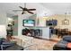 Open-concept living room and kitchen with hardwood floors, modern lighting, and comfortable seating at 129 Mockernut Dr, Ladson, SC 29456