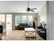 Living room with hardwood floors, leather sofas, ceiling fan, and natural light at 129 Mockernut Dr, Ladson, SC 29456