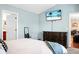 Spacious main bedroom featuring an entertainment center and access to the bathroom and hallway at 129 Mockernut Dr, Ladson, SC 29456