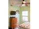 Light green bedroom features a ceiling fan and wooden dresser at 1300 Park West Blvd # 919, Mount Pleasant, SC 29466