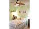 Green bedroom features a patterned quilt, wooden nightstand and beach artwork at 1300 Park West Blvd # 919, Mount Pleasant, SC 29466