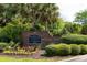 Elegant brick entrance sign for Madison at Park West surrounded by colorful flowers and greenery at 1300 Park West Blvd # 919, Mount Pleasant, SC 29466