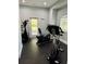 Well-equipped gym featuring a stationary bike and elliptical machine near a door and window at 1300 Park West Blvd # 919, Mount Pleasant, SC 29466