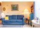 Comfortable living room featuring a blue sofa, sunny yellow walls, carpet flooring, and soft lighting at 1300 Park West Blvd # 919, Mount Pleasant, SC 29466