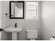 Half bathroom featuring modern fixtures, a pedestal sink, and neutral colors at 132 E Hartwick Ln, Goose Creek, SC 29445