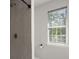 Bright bathroom featuring tiled shower and window allowing natural light at 132 E Hartwick Ln, Goose Creek, SC 29445