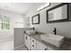 Modern bathroom with dual vanities, granite countertops, and stylish black fixtures at 132 E Hartwick Ln, Goose Creek, SC 29445
