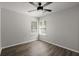 Bright bedroom featuring hardwood floors, ceiling fan, and sunlit windows with blinds at 132 E Hartwick Ln, Goose Creek, SC 29445
